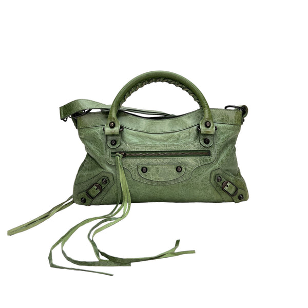 The First Top handle bag in Distressed leather, Antique Brass Hardware