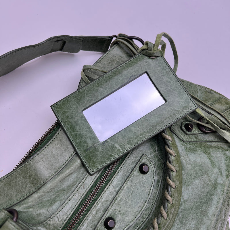 The First Top handle bag in Distressed leather, Antique Brass Hardware